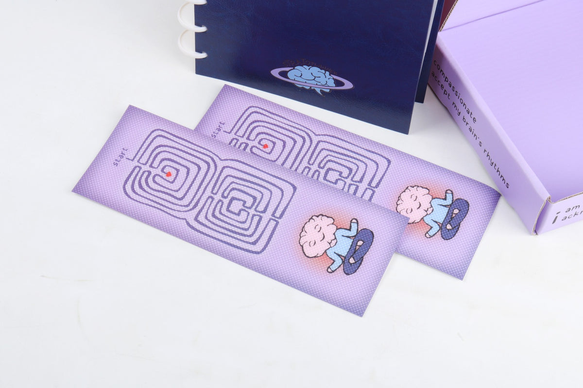 StratoPlanner bookmark inserts with maze and brain graphics, shown with packaging